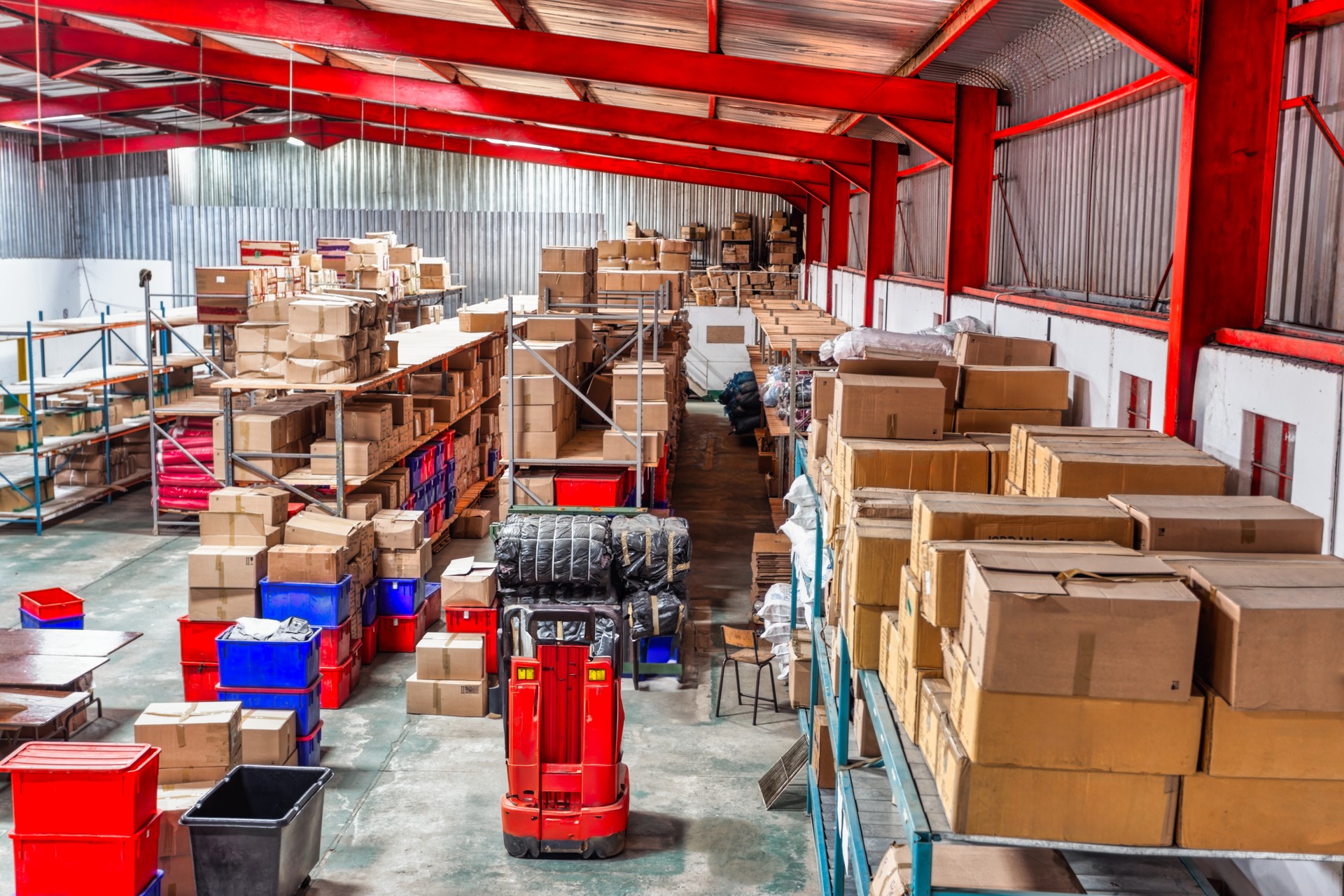 huge warehouse  with carton card and plastic crates boxes in shelfs, high point of view