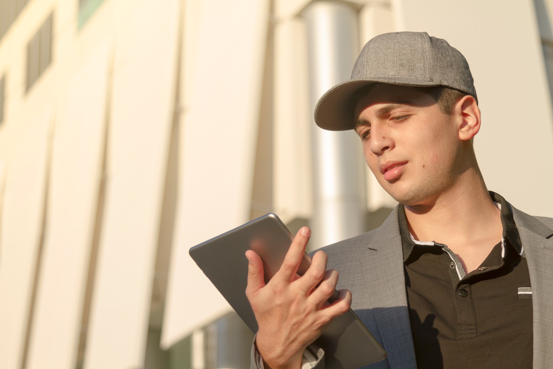 Young latin teenager businessman working using a digital tablet with 5G technology in United States of America USA.